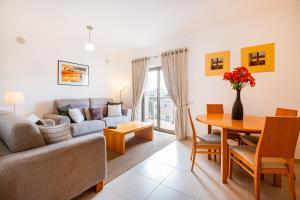 a living room with a couch and a table at Solarium Luxury Apartment by Atlantic Places in Albufeira
