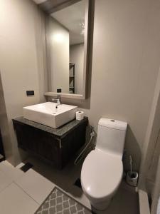 a bathroom with a white toilet and a sink at The Serena Suite in Manila +9 photos