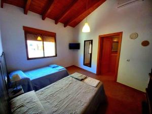 une chambre avec deux lits et une fenêtre dans l'établissement Apartamentos Casas Venta Ticiano, à Yeste