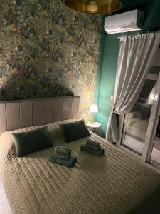 a bedroom with a large bed with two pillows on it at RHODESIA guest house in Chalkida