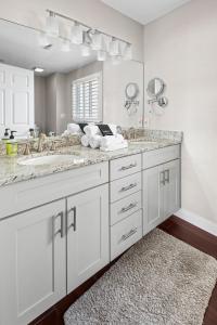 a bathroom with two sinks and a large mirror at 21 Mile Marker Overlook in Osage Beach