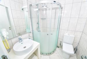 a bathroom with a shower and a sink and a toilet at Kalina Hotel in Datca +65 photos