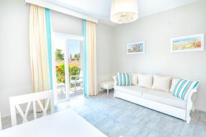 a white living room with a couch and a window at Kalina Hotel in Datca