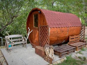 a small wooden house with a bench and a chair at La Cà di Gatt in Monteleone