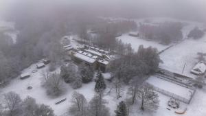 an aerial view of a building covered in snow at Kambarys Šiaurėje in Kaltanėnai