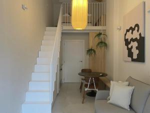 a white staircase in a living room with a table at Osito Hub - Poeta Durán in Valencia