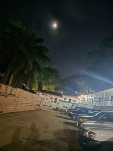 a row of cars parked in a parking lot at night at cite blanche in Bangui