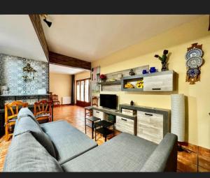 a living room with a couch and a table at La Pedriza LA CASA DEL GALAPAGAR in Galapagar