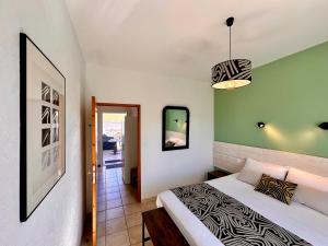 a bedroom with a bed and a pendant light at L'Ostal de Soubrey in Salettes
