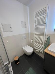 a white bathroom with a toilet and a sink at Wohnung Leverkusen I Garage I 4 Schlafzimmer in Leverkusen