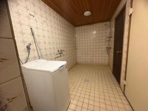 a bathroom with a toilet and a sink and a shower at Kimito Village in Kemiönsaari +17 photos