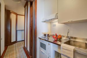 a kitchen with a sink and a bowl of fruit on the counter at Appartamento Principino 24 Ski in Ski out - Happy Rentals in Sestriere