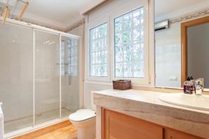 Un baño con ducha, inodoro y lavabo. en Villa Drago, en Castelldefels 19 fotos más