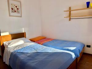 A bed or beds in a room at Al civico 7 Relax a due passi dal lago di Como