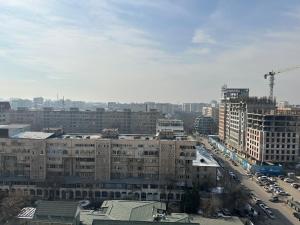 a view of a city with buildings and cars at Lovely house in the city center in Bishkek +3 photos