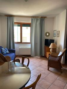 a living room with a table and a couch at Casa Roberta in Alghero