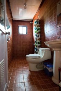 a bathroom with a toilet and a sink at RELAX White house, Puerto Galera in Puerto Galera +40 photos