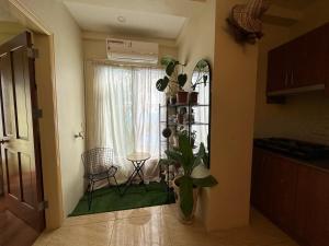 a room with a window with a table and a plant at Centrally Located Affordable Apartment with Kitchen in Boracay