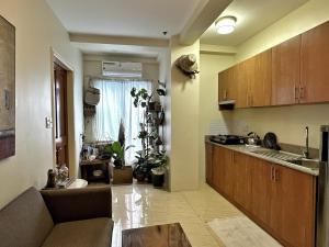 a kitchen with a couch and a table in a room at Centrally Located Affordable Apartment with Kitchen in Boracay