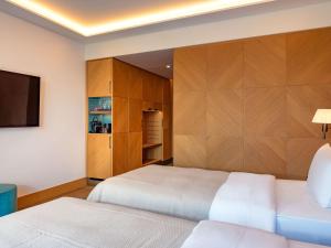 Postel nebo postele na pokoji v ubytování Mövenpick Hotel Basel