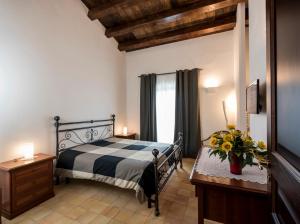 a bedroom with a bed and a dresser and a window at Agriturismo Raffo in Naro