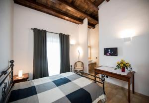 a bedroom with a bed and a desk and a window at Agriturismo Raffo in Naro +41 photos