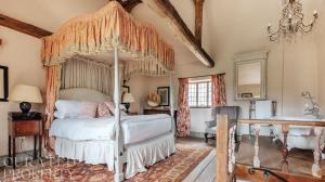 a bedroom with a canopy bed and a sink at Lavish Tudor Estate & Gardens - Sleeps 20 in Hales