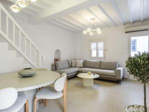 a living room with a couch and a table at Plateia House Mykonos in Mikonos