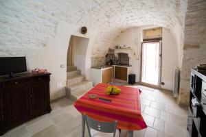 a kitchen with a table with a red cloth on it at Borgovecchio Suite in Ostuni