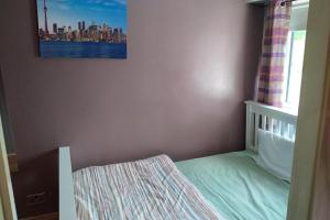 a small bedroom with a bed and a window at Cosy Cottage- Sleeps 4 Free Parking & Golf Nearby in Buncrana