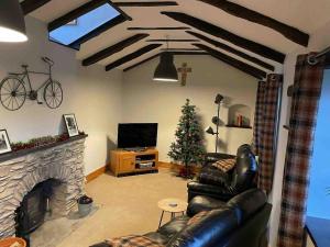 a living room with a couch and a christmas tree at Littlecross Cottage in Barnstaple