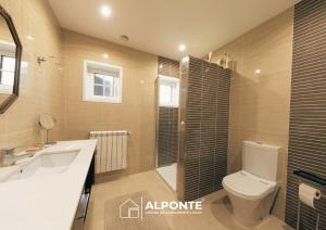 a bathroom with a toilet and a sink and a shower at Casa da Melanie in Caminha +76 photos