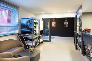 a living room with a couch and a window at Automobil Hotel in Krak&oacute;w