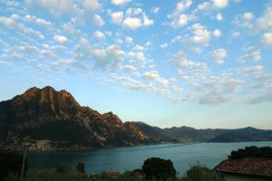 a view of a lake and mountains under a cloudy sky at IseoLakeRental - Villa Retrò in Riva di Solto