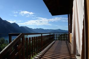 a balcony with a view of the water and mountains at IseoLakeRental - Villa Retrò in Riva di Solto
