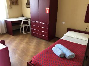 a bedroom with a bed with two towels on it at IseoLakeRental - Villa Retrò in Riva di Solto +14 photos