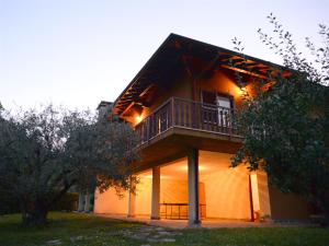 a house with a balcony on the side of it at IseoLakeRental - Villa Retrò in Riva di Solto