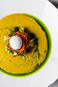 a yellow dish with an egg on top of it at GRANO HOTEL Solmarina in Wiślinka