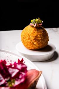 a piece of food on a plate on a table at GRANO HOTEL Solmarina in Wiślinka