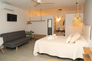 a bedroom with a large bed and a couch at Calas De Meca in Los Caños de Meca