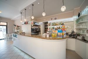 a large kitchen with a counter in a store at Risorgimento - Albergo - Bar in Morciano di Romagna