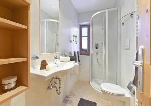 a white bathroom with a sink and a shower at Appartments Radauerhof in Castelrotto +20 photos