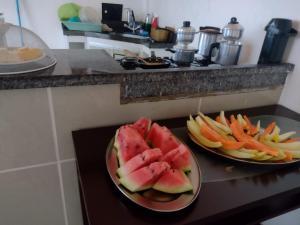 two plates of fruit on a counter in a kitchen at Hotel e Pousada dos Leões in São Luís +15 photos