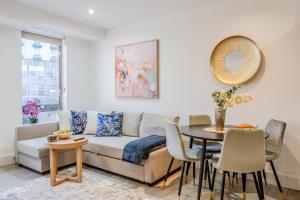 a living room with a couch and a table at Arliss Suite in Watford