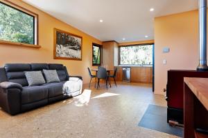 a living room with a couch and a table at Hidden Retreat in Royal Park
