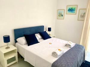 a bedroom with a large bed with towels on it at Casa Segovia By Solymar Holiday in Caleta De Velez +38 photos