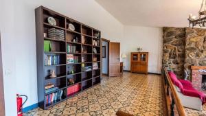 a living room with a large book shelf at Spacious Villa with Private Pool in Monachil in Monachil