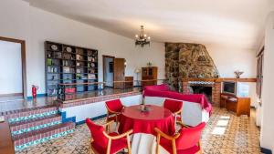 a living room with a table and red chairs at Spacious Villa with Private Pool in Monachil in Monachil