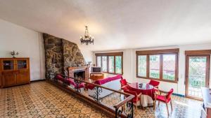 a living room with a fireplace and a table and chairs at Spacious Villa with Private Pool in Monachil in Monachil