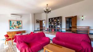 a living room with a red couch and a table at Spacious Villa with Private Pool in Monachil in Monachil